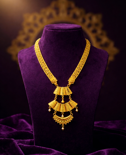 Gold necklace on a purple mannequin with a dark background