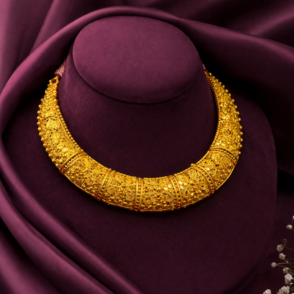 Gold necklace on a purple cushion with a soft focus background